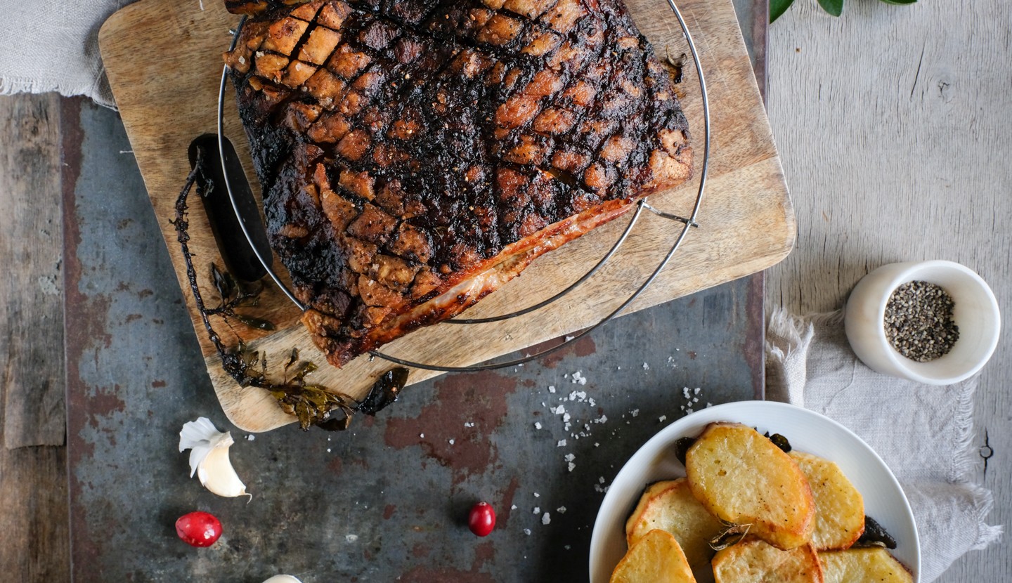 Roast pork belly with potatoes and cranberry sauce